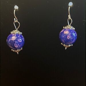 Handcrafted purple and silver tone earrings.